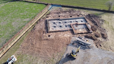 yellow and black heavy equipment on brown field during daytime