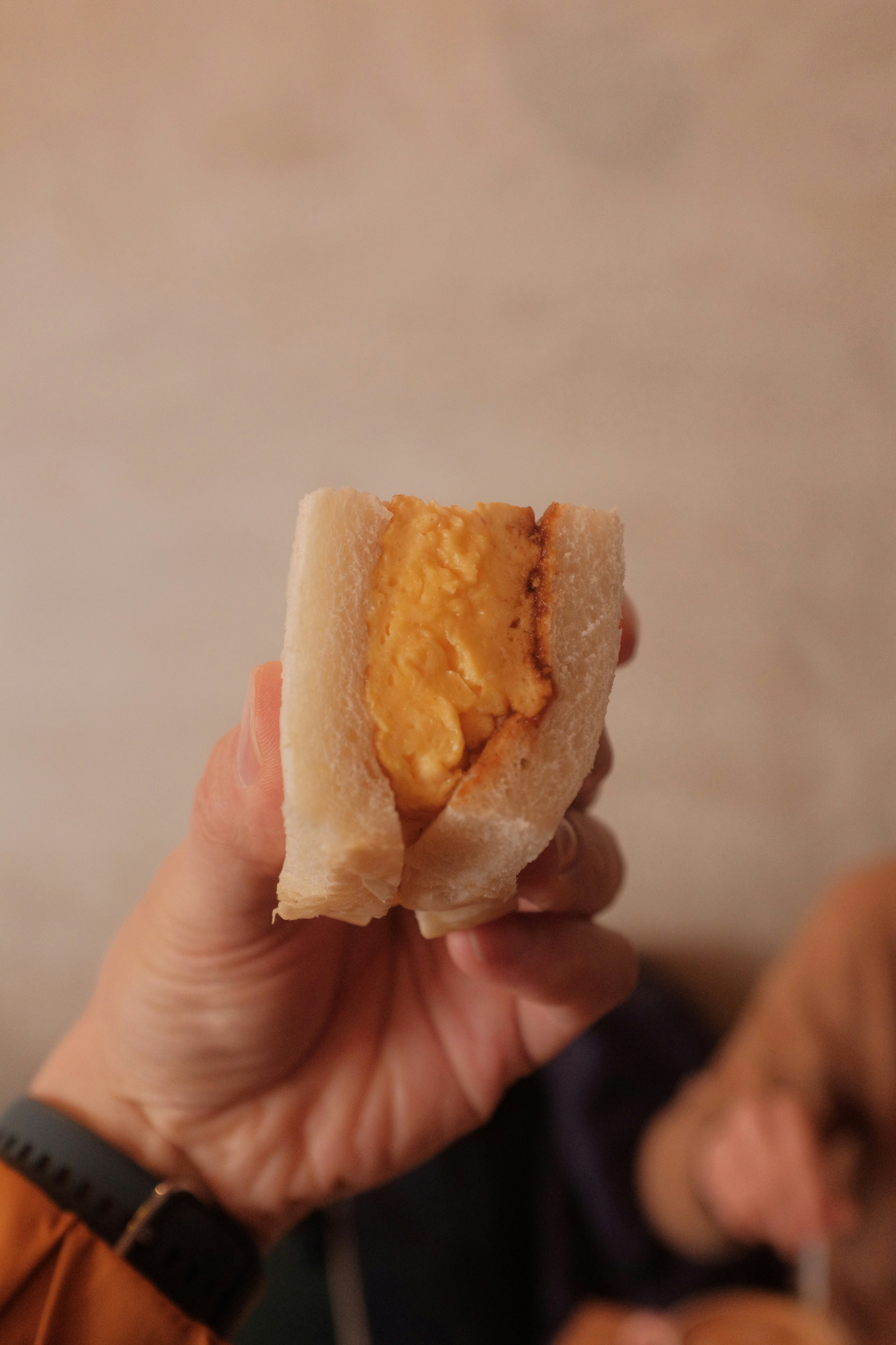 person holding bread with cheese