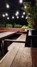 Outdoor patio decorated with wooden elements and soft ambient lighting.