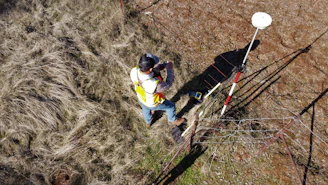 A scientist in a field taking soil samples for environmental site assessment.