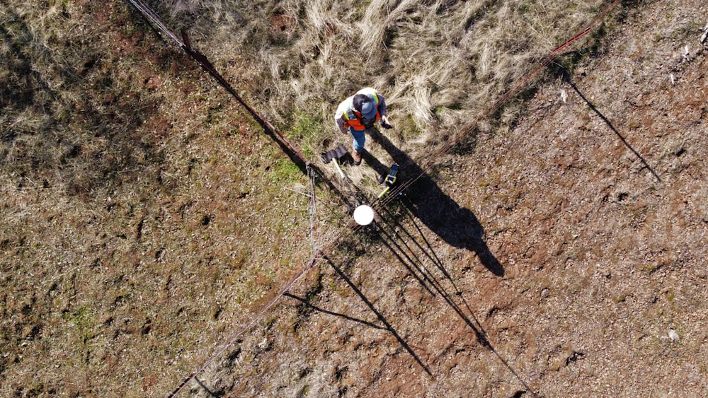 man in black pants and white helmet holding black and white stick