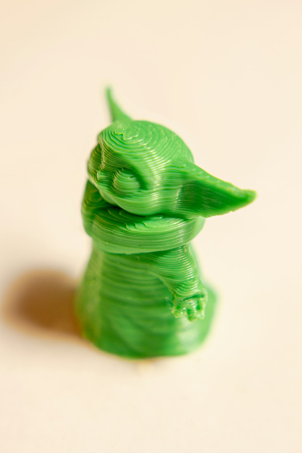 green dragon figurine on white surface