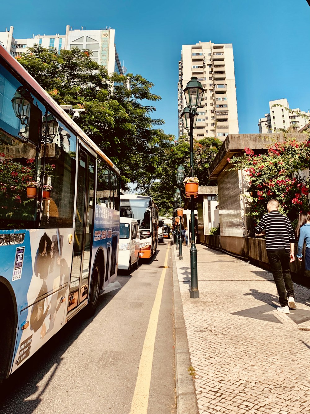 blue and white bus on road during daytime