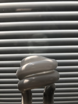 A close-up of energy-efficient light bulbs on a shelf.
