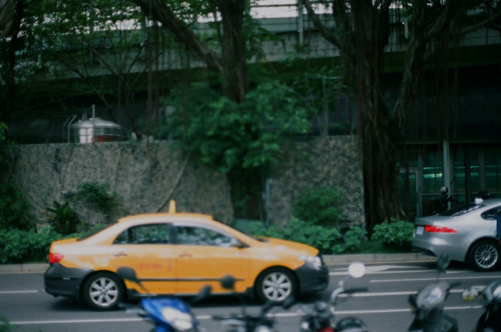 yellow and black sedan on road