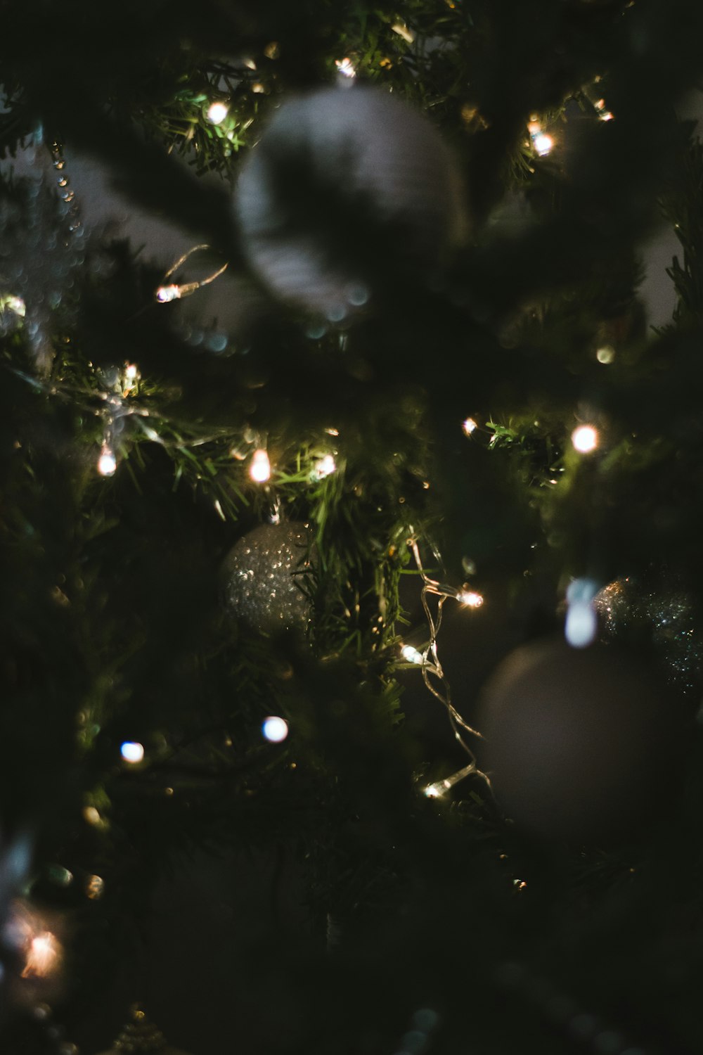 silver baubles on green christmas tree