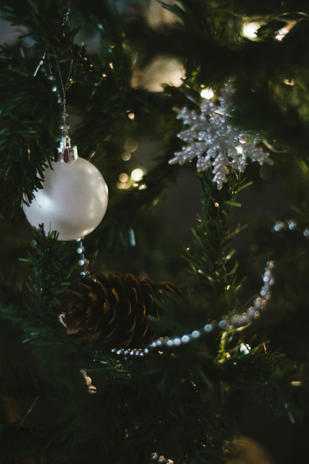 white christmas bauble on green christmas tree