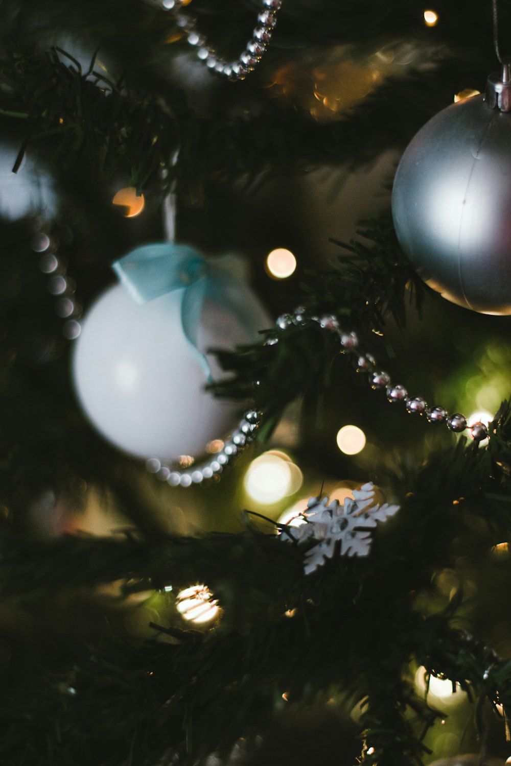 white and blue bauble on christmas tree