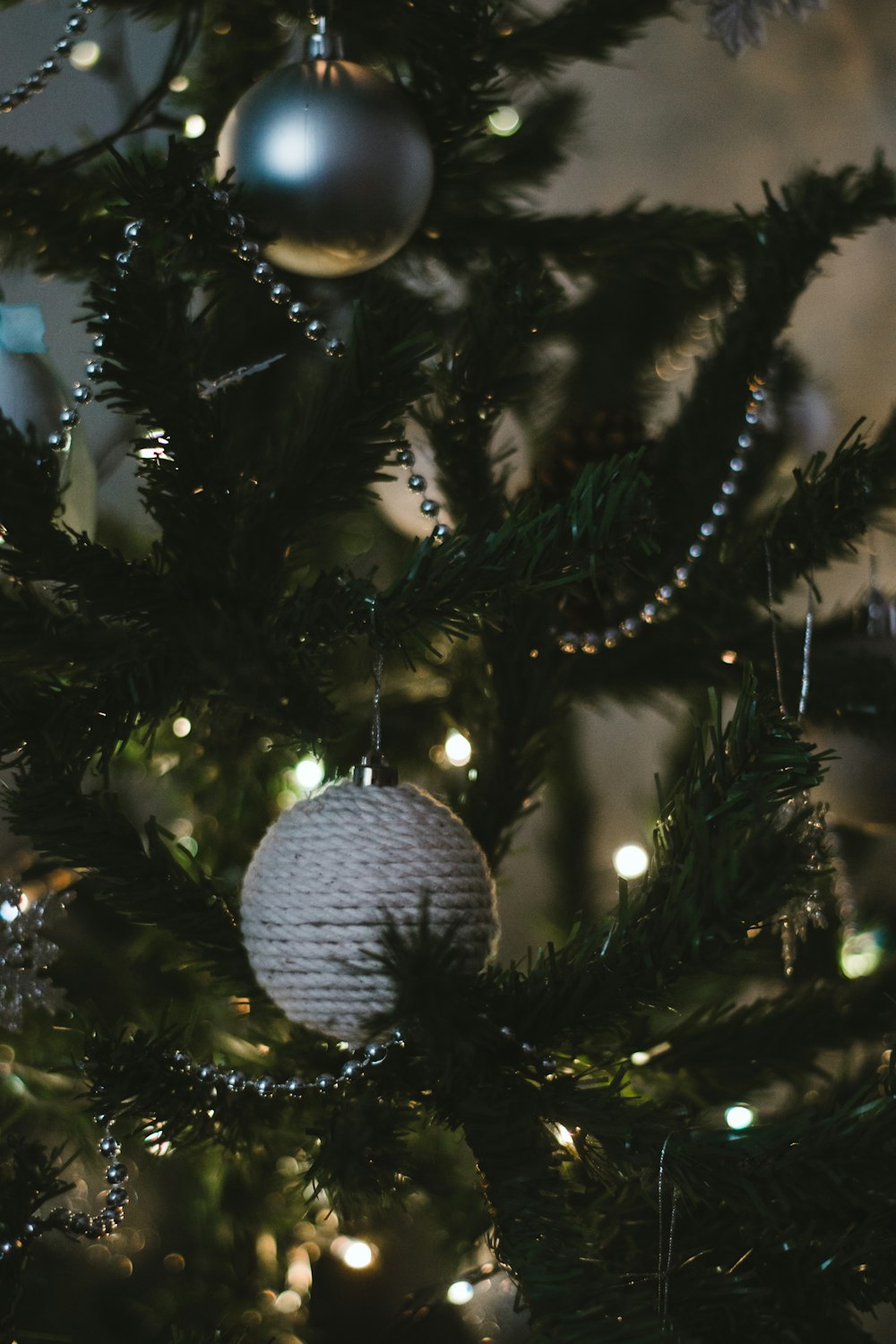 silver bauble on green christmas tree