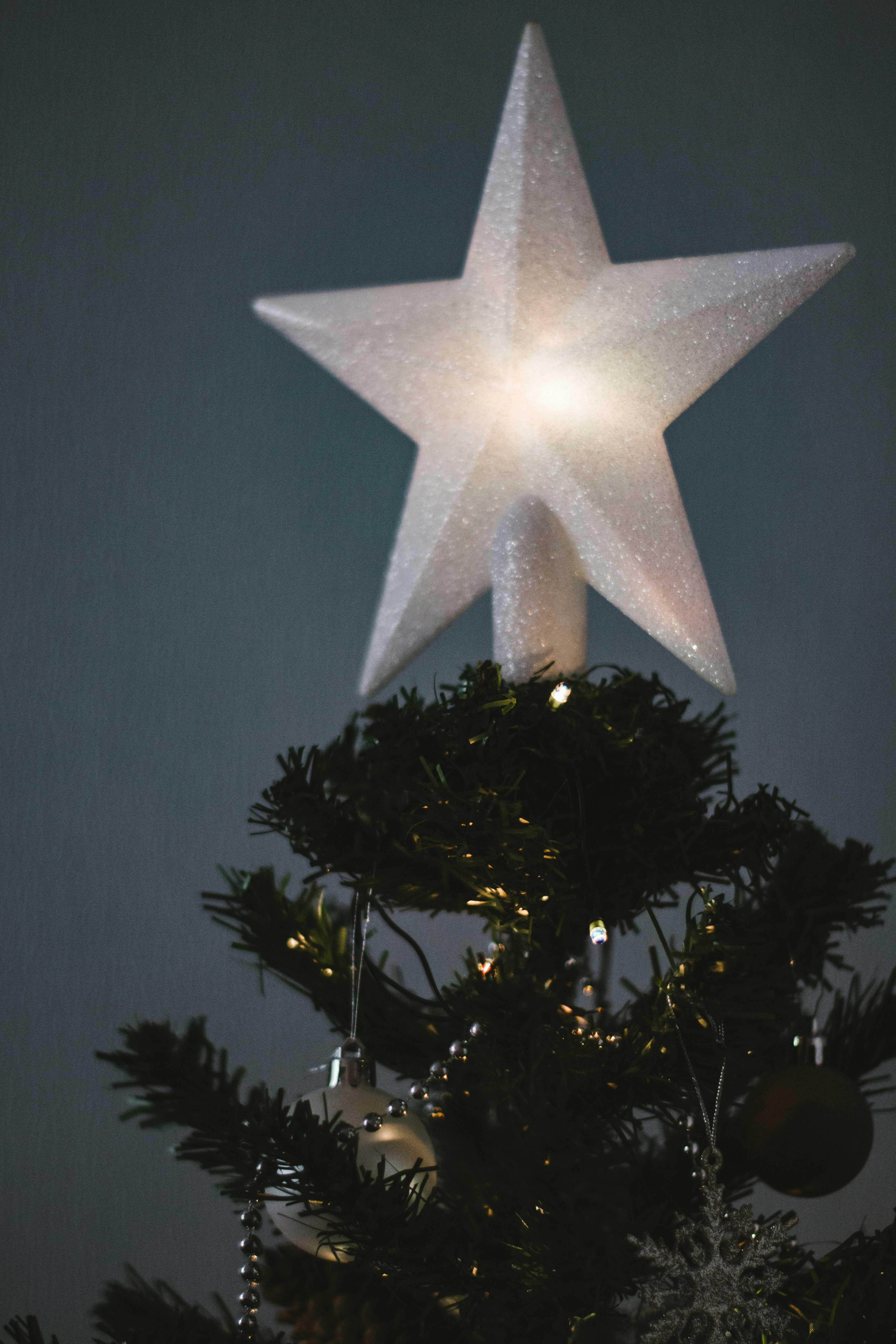 white star ornament on green christmas tree