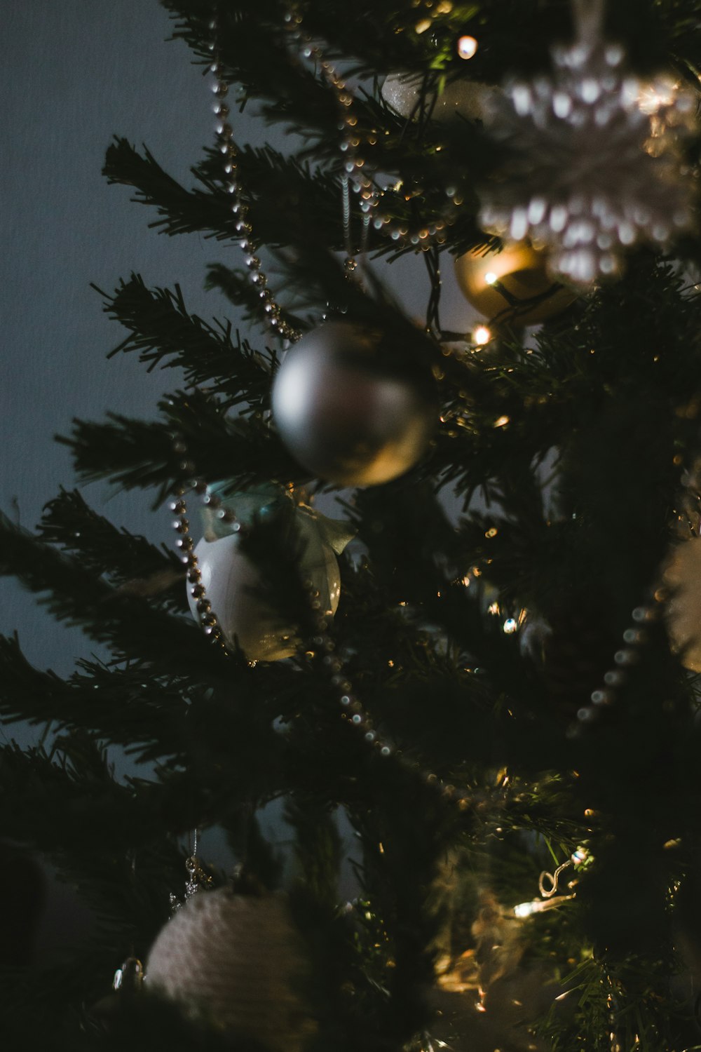 silver baubles on green christmas tree