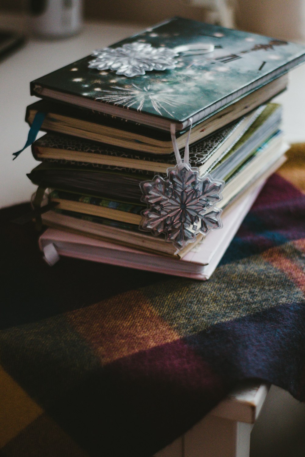 stack of books on brown and black textile