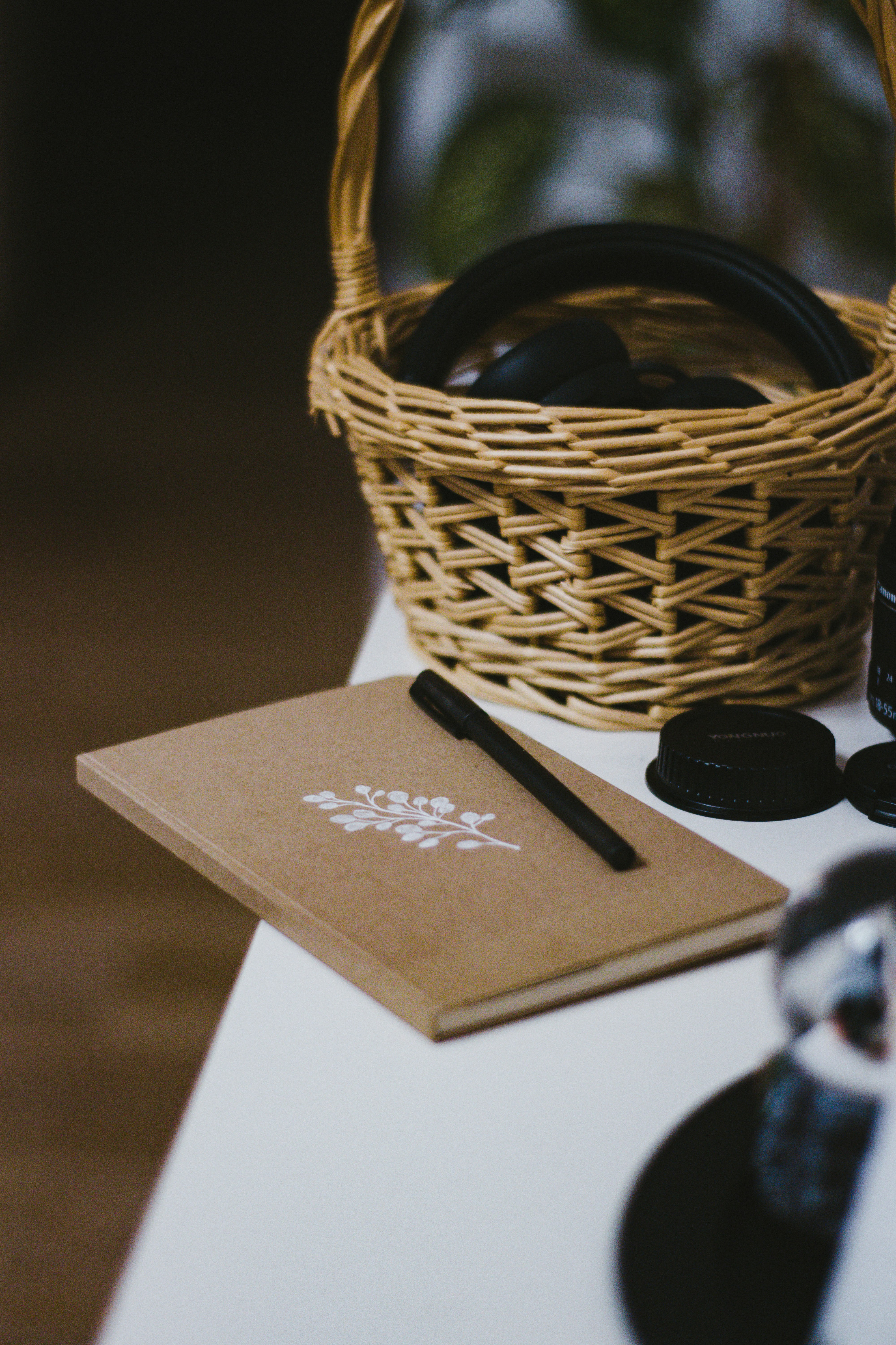 black pen on white paper beside brown woven basket