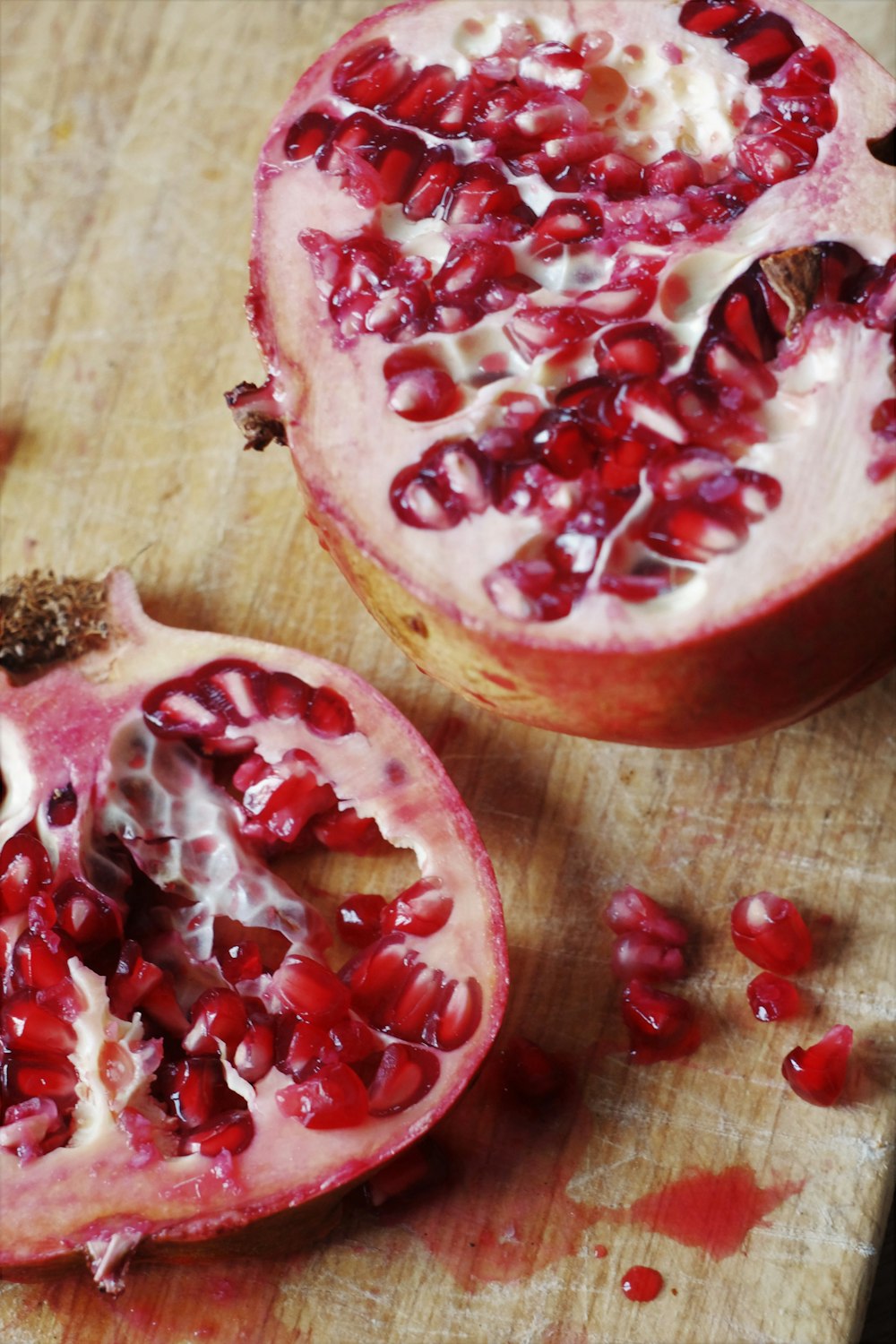 sliced pomegranate on brown wooden table