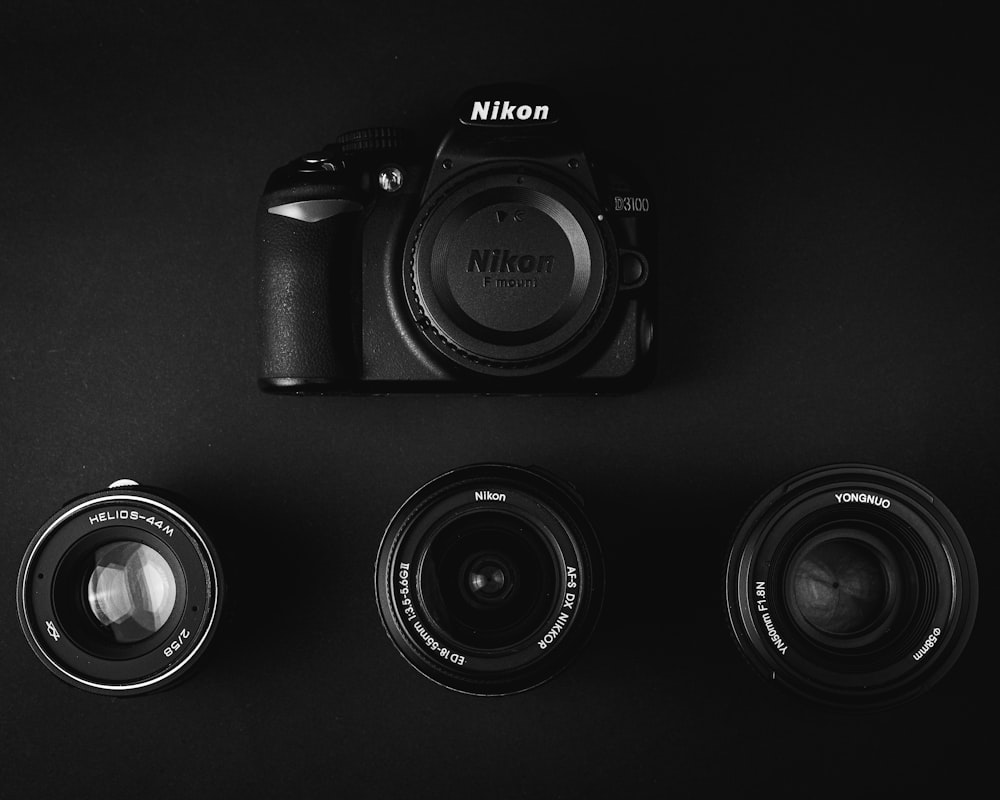 black nikon dslr camera on black surface