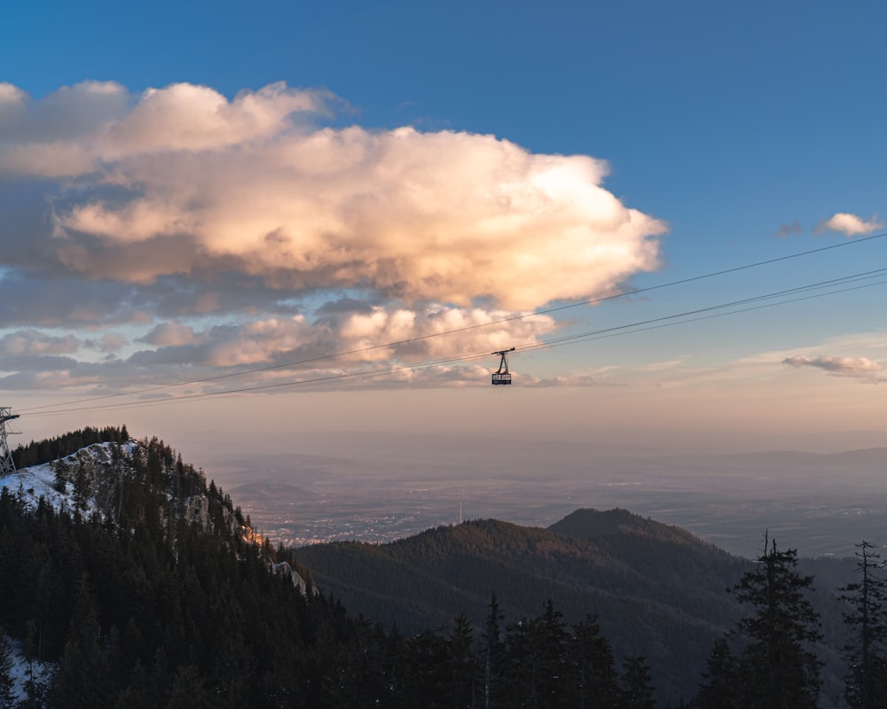 person standing on top of mountain during daytime