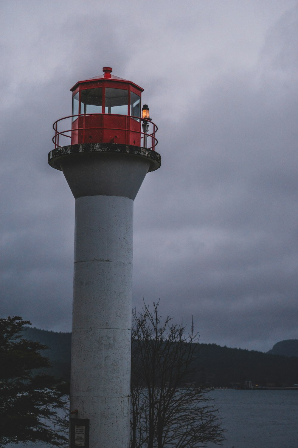 red and white concrete tower under gray clouds