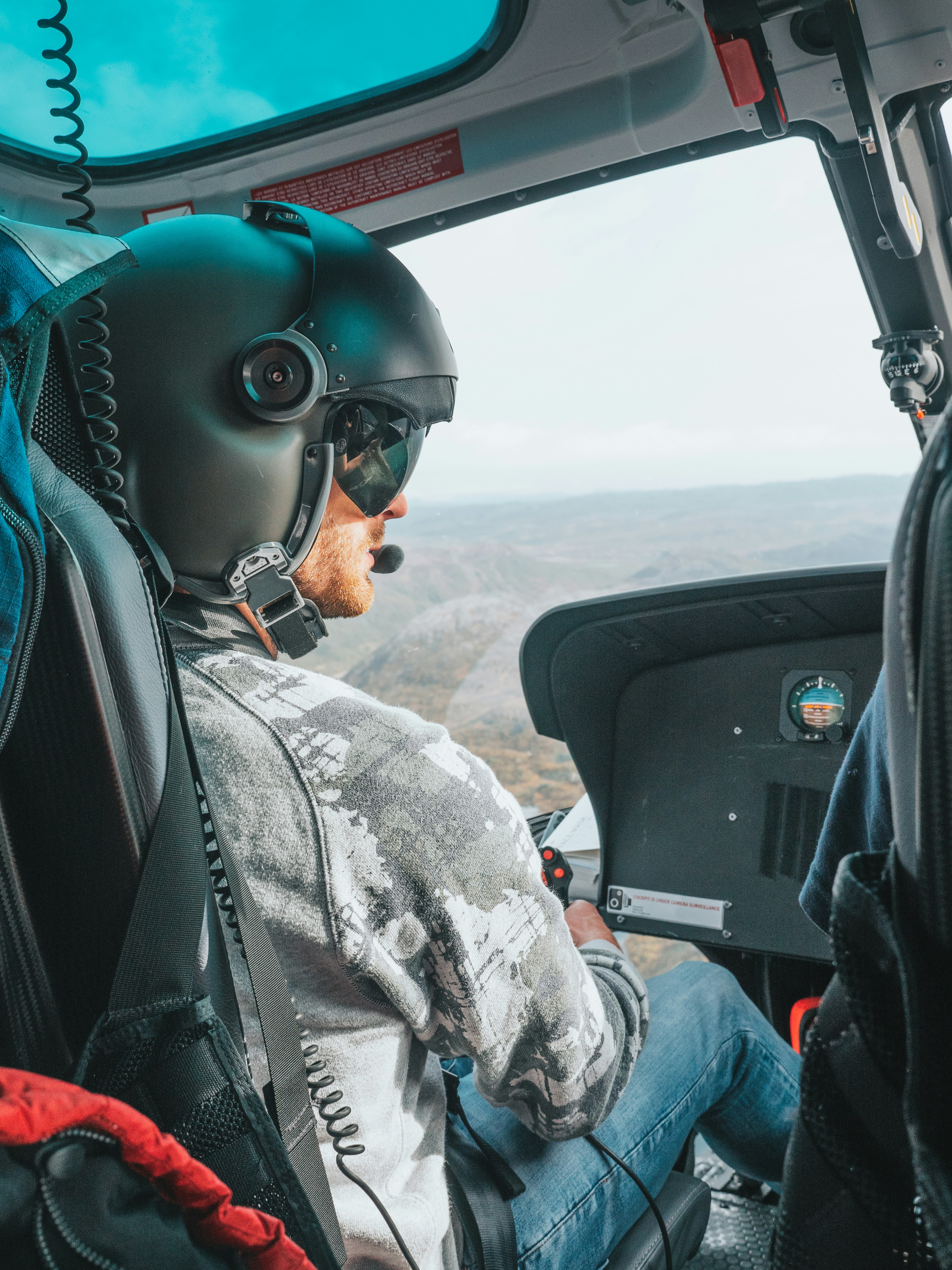 man in black sunglasses and black helmet driving car during daytime