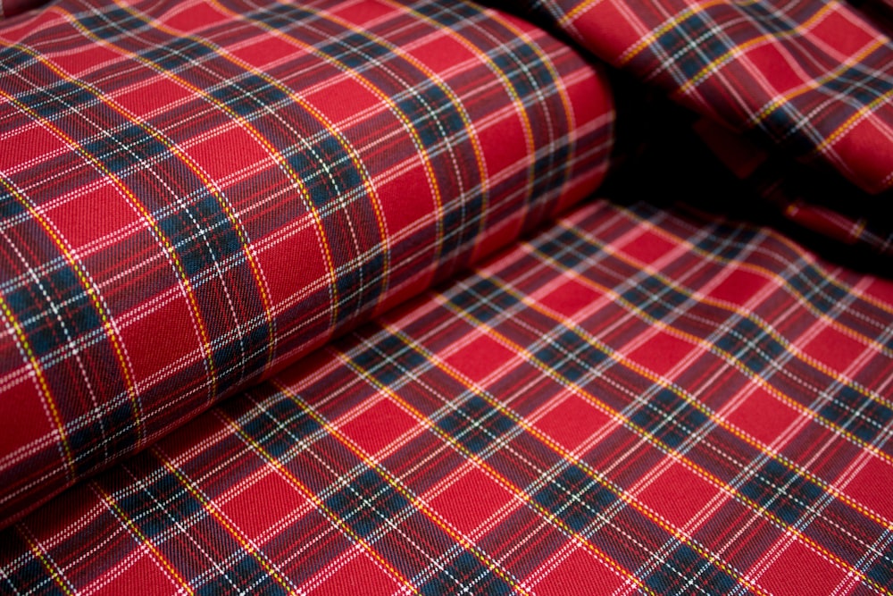 red white and black plaid textile