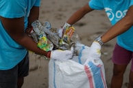 person in blue t-shirt holding white textile