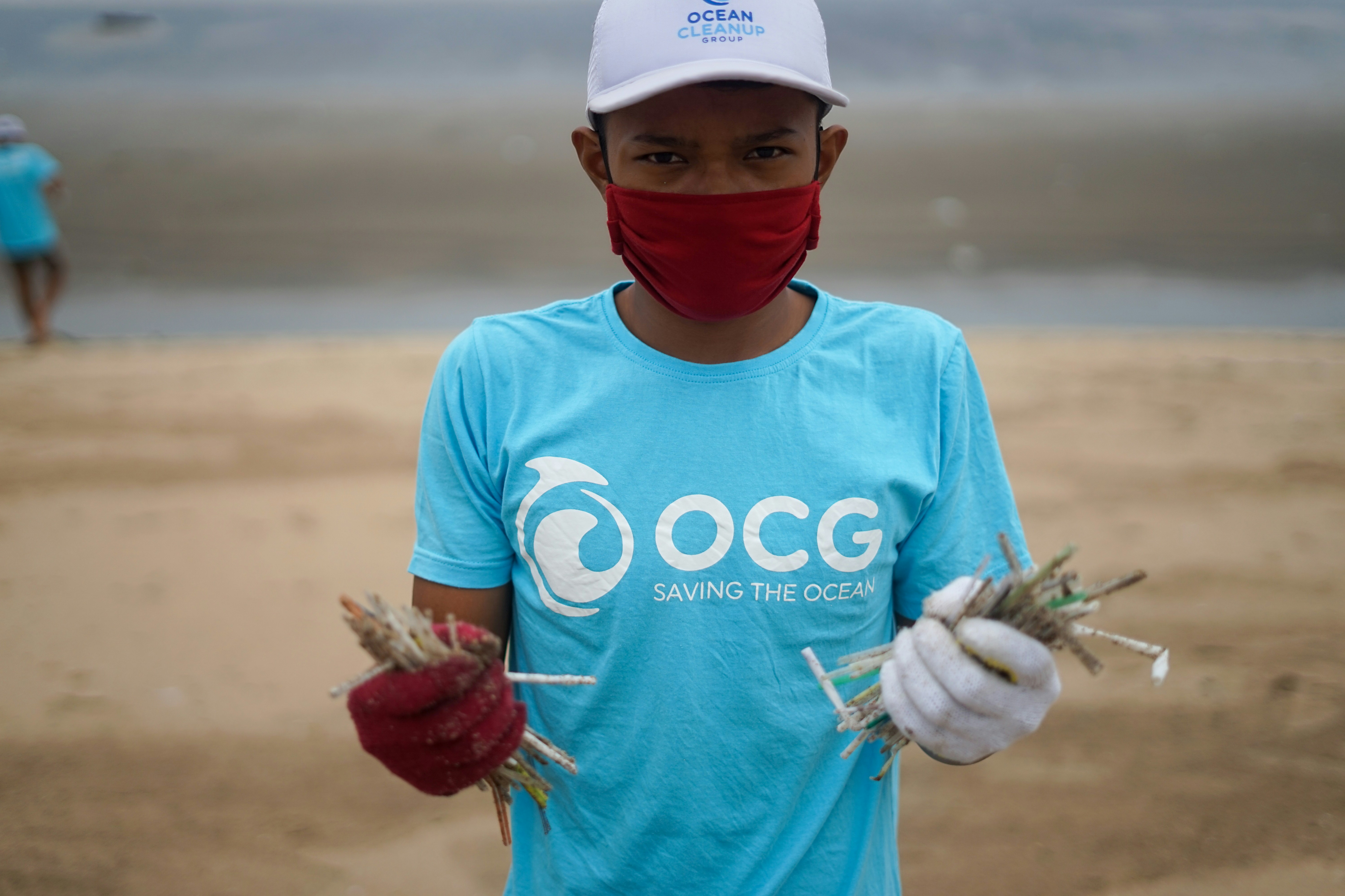 Young volunteer holding ocean cleanup materials