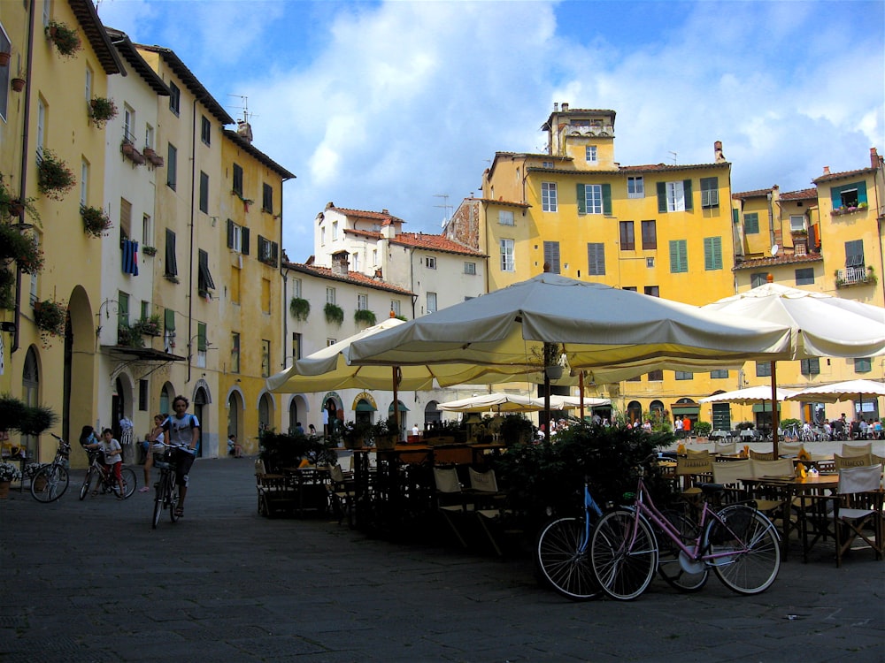 people walking on street near yellow concrete building during daytime