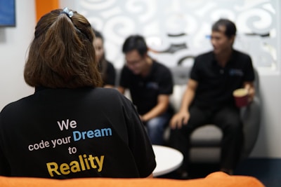 woman in black crew neck t-shirt sitting on chair