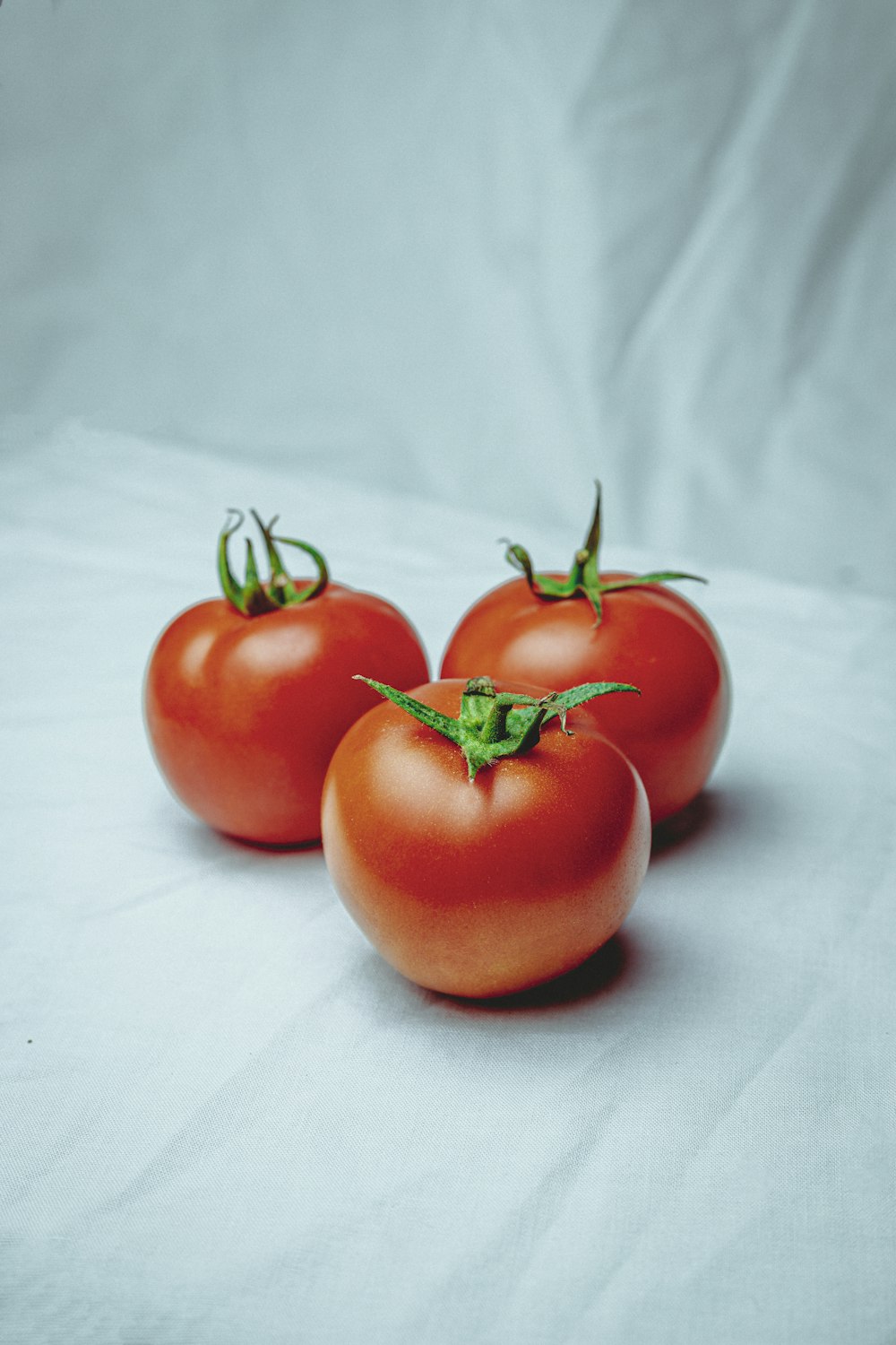 red tomato on white textile