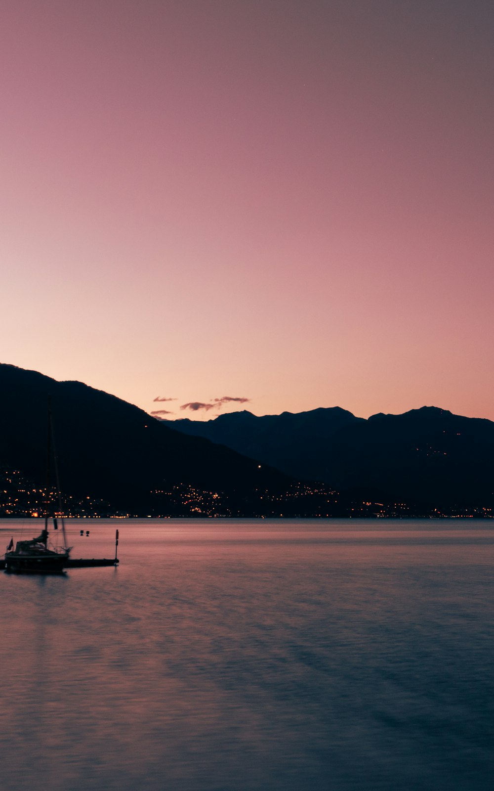 silhouette of boat on water during sunset