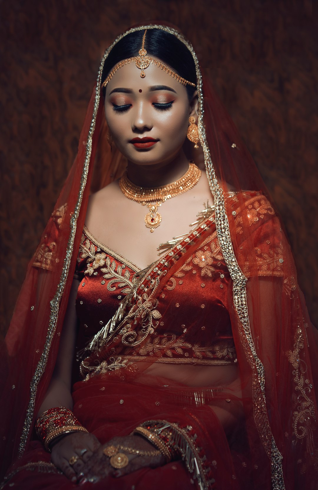 woman in red and gold sari