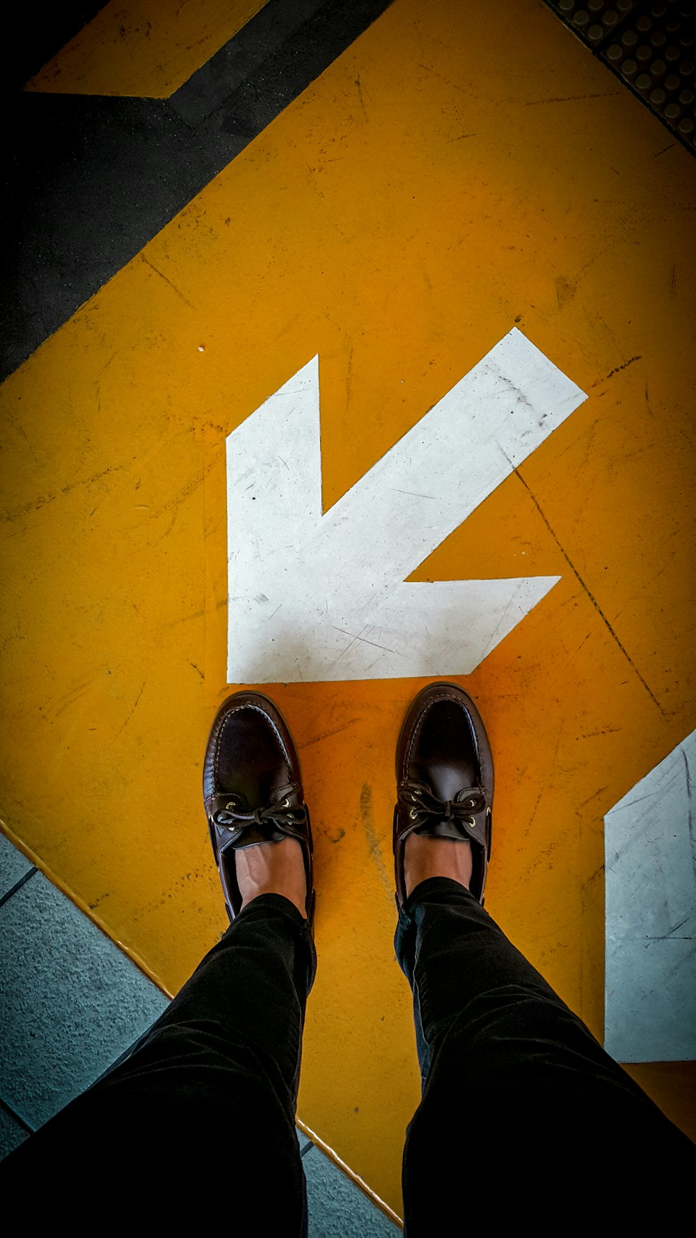 person wearing black leather shoes