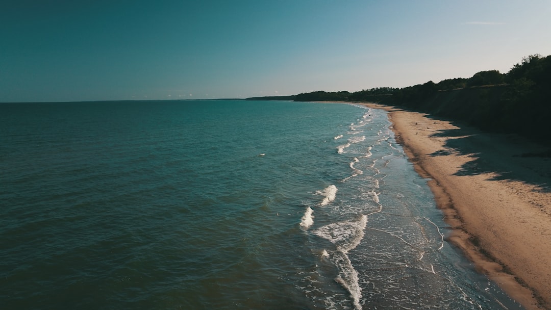 sea waves crashing on shore during daytime