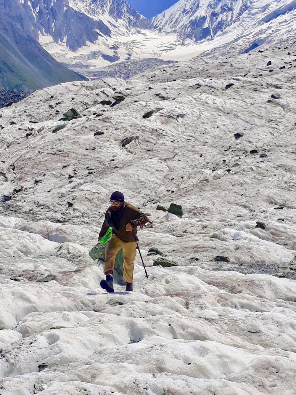 a man hiking up a snow covered mountain