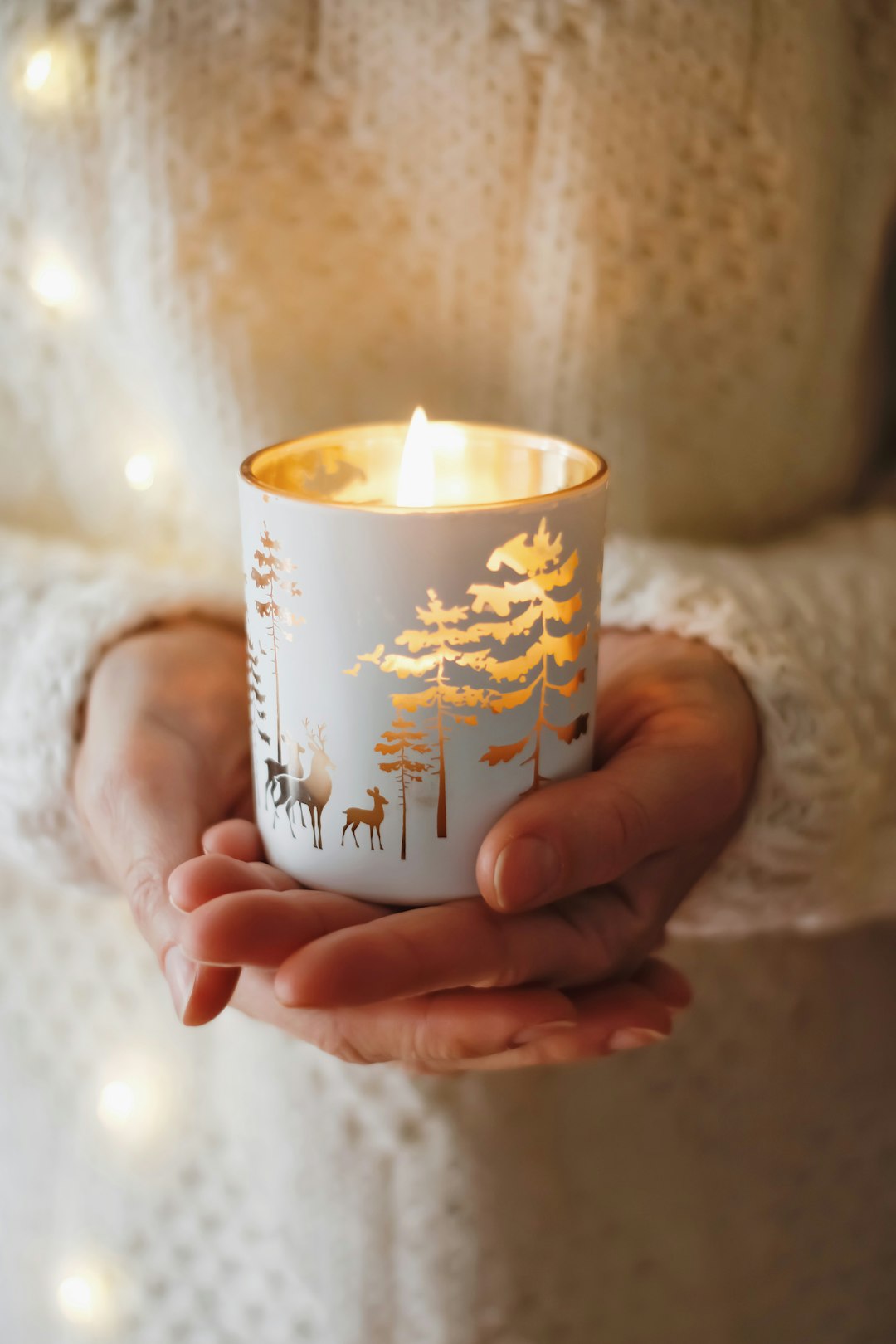 person holding white and brown ceramic mug