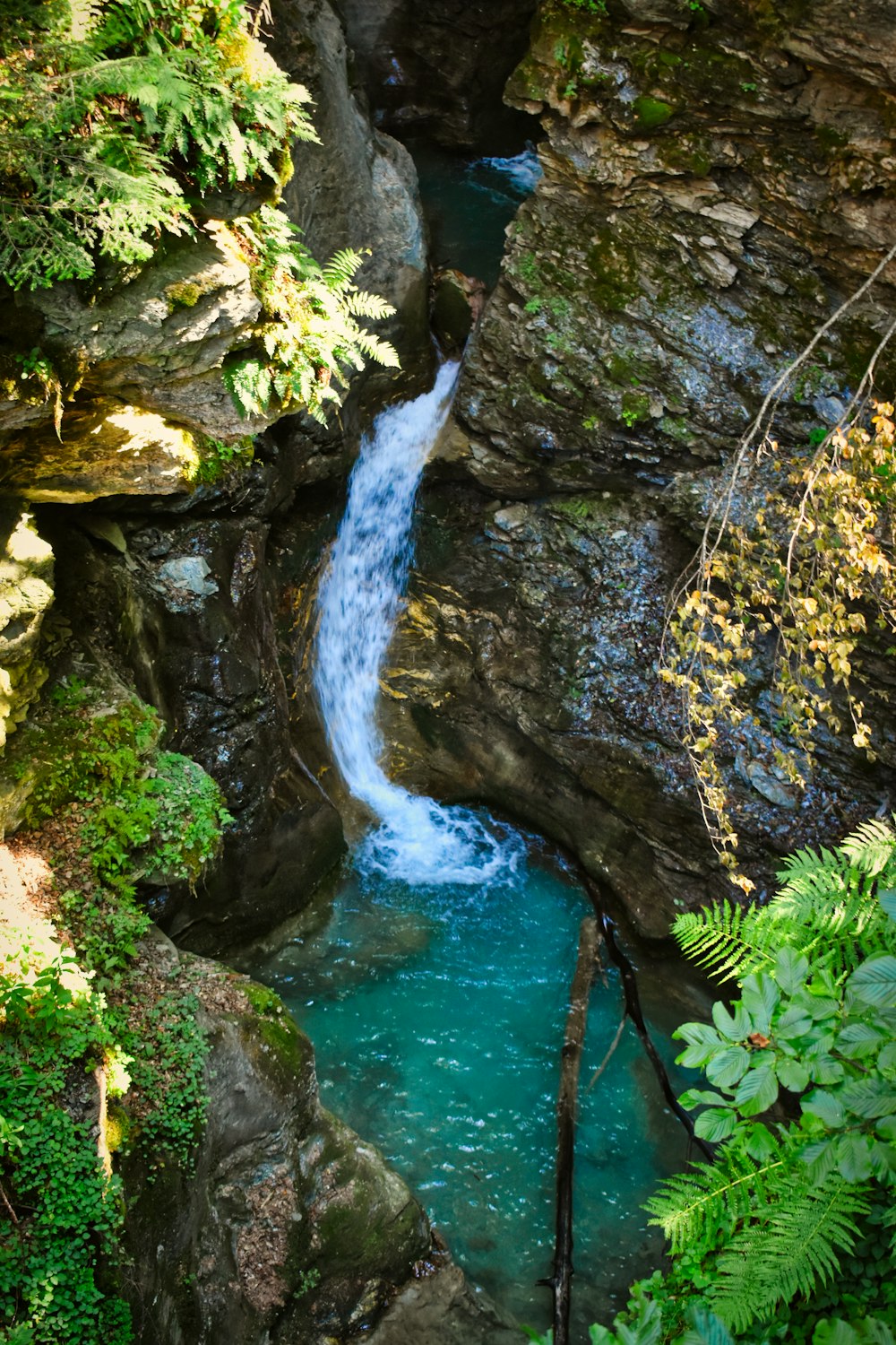 water falls in the middle of rocky mountain