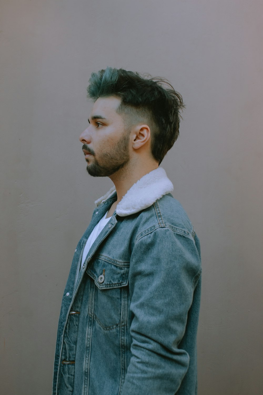 man in blue denim button up jacket