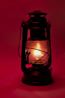 black lantern lamp turned on in red room