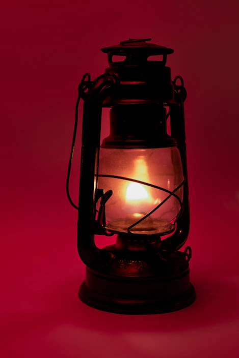 black lantern lamp turned on in red room