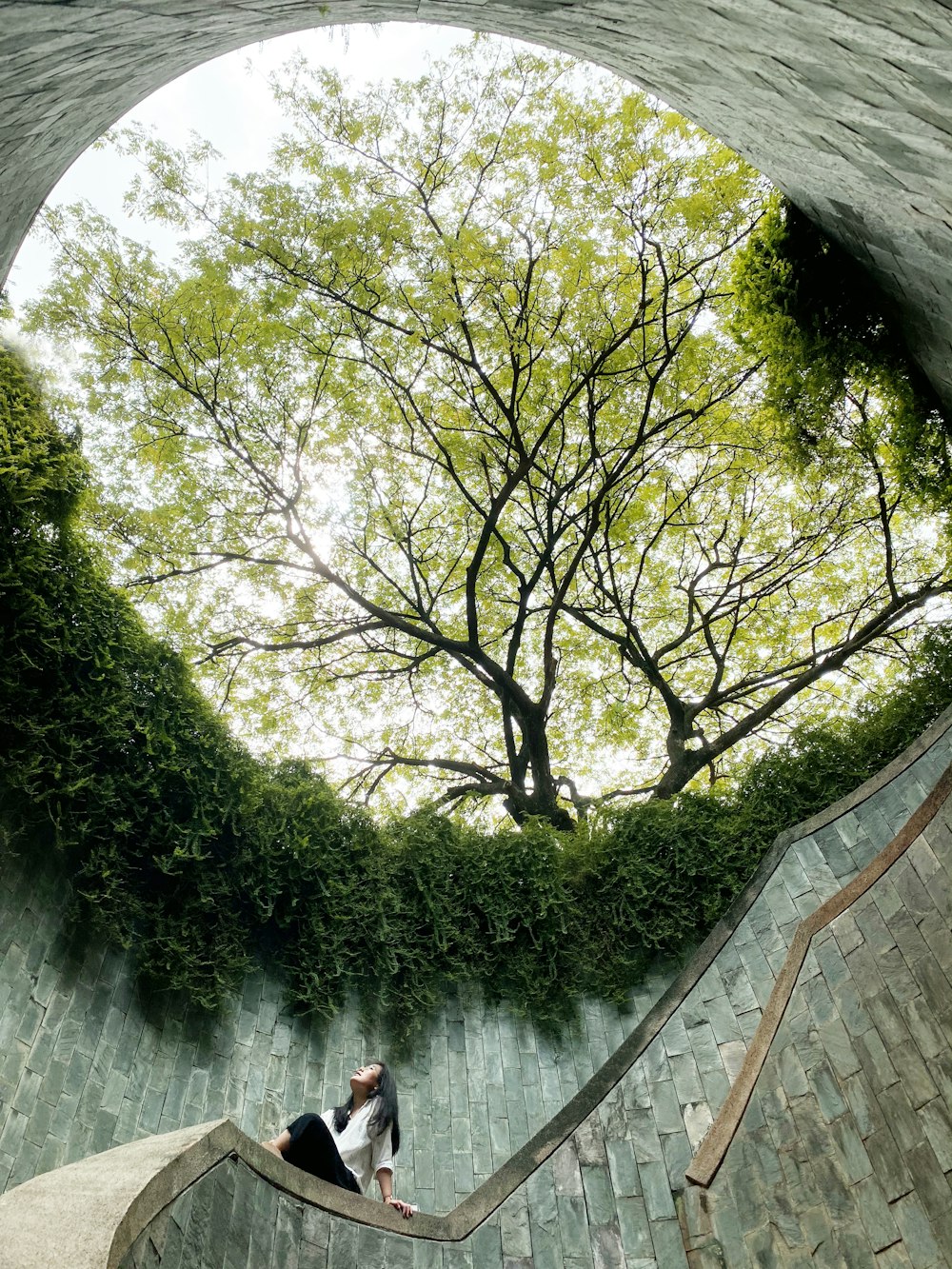 person in red jacket walking on wooden bridge