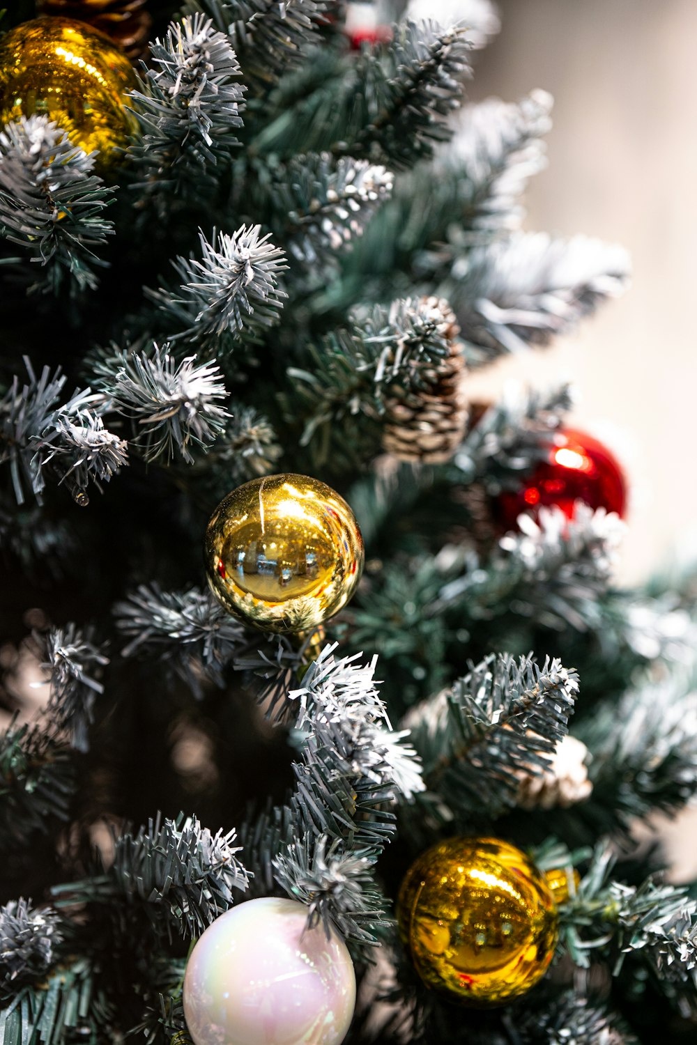 a close up of a christmas tree with ornaments