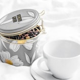 Elegant tea tins stacked, showcasing regal gold and green design elements.