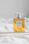 a bottle of perfume sitting on top of a bed