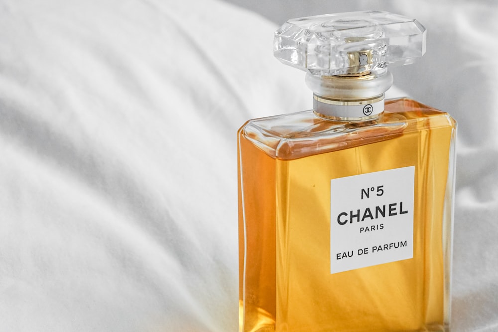 a bottle of chanel no 5 on a bed