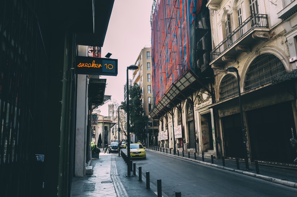 yellow taxi cab on street during daytime