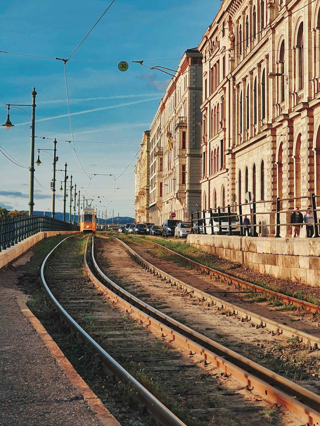 train rail near brown concrete building during daytime