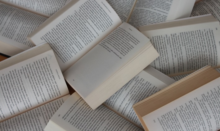 white and brown book on brown woven surface