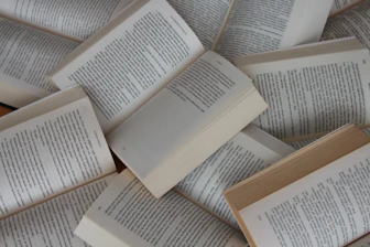 white and brown book on brown woven surface