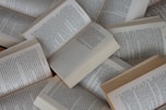 white and brown book on brown woven surface