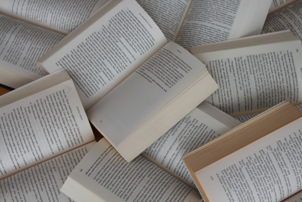 white and brown book on brown woven surface