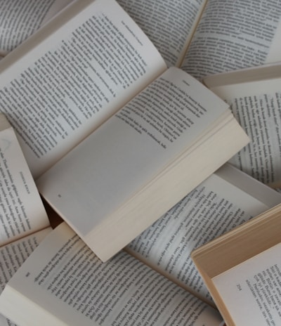 white and brown book on brown woven surface